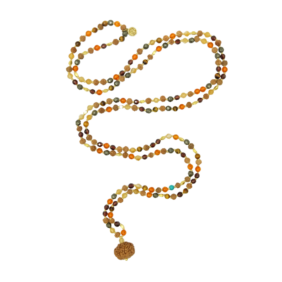 A beautifully handcrafted Lakshmi Mala composed of 216 beads featuring Citrine, Garnet, Pyrite, Amber, Tigers Eye, Turquoise, 4mm Rudraksha seeds, and 22k gold-plated accents. The mala exudes an aura of abundance and protection.
