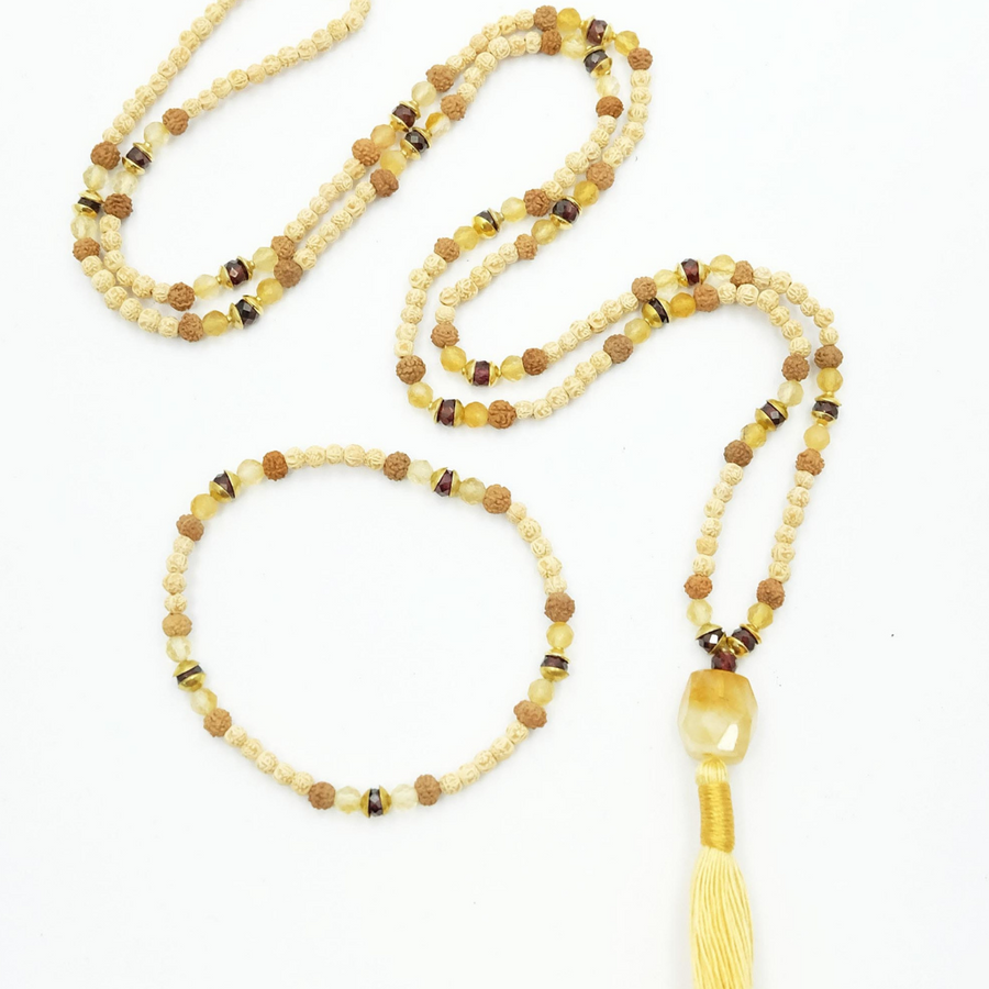 Prayer bead mala made from rudrani, rudraksha, citrine and garnet beads with cotton tassel. 